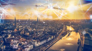 Blick auf die Smart City Lübeck von oben bei Sonnenuntergangsstimmung